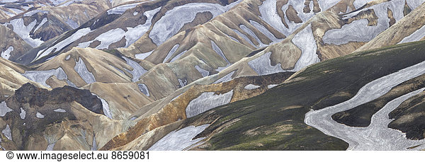 An aerial view of the Landmannalaugar Mountains in Iceland. Rhyolite mountains and expansive lava fields.