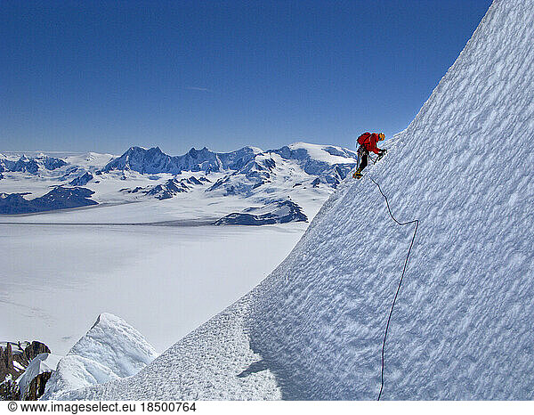An alpinist climbs an ice slope on the west face of Cerro Torre.