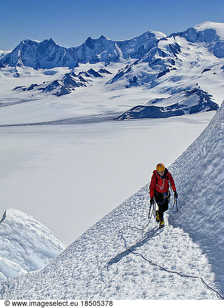 An alpinist climbs an ice slope on the west face of Cerro Torre.