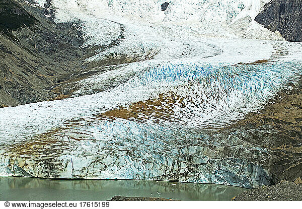An Andean glacier flows into a Patagonian lake  Glaciar Torre flowing down Cerro Torre and into Lago Torre near El Chalten in Parque Nacional Los Glaciares; Patagonia  Argentina