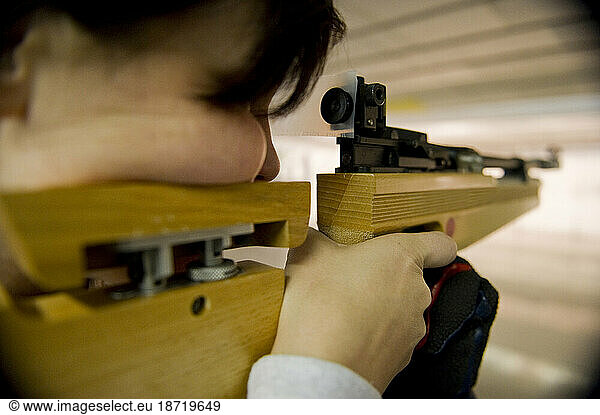 An athlete fires her air rifle during practice.