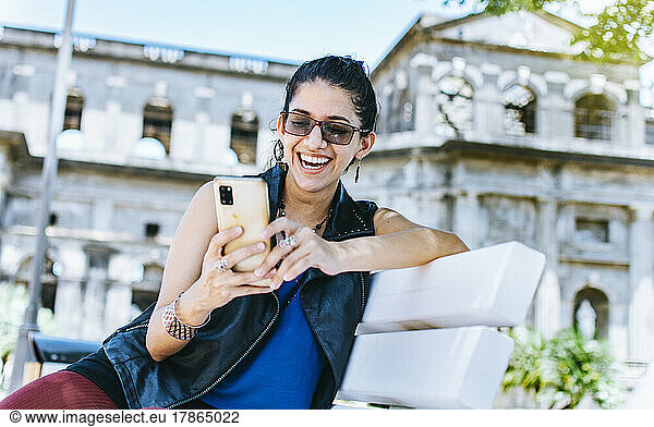 An attractive girl sitting on the cell phone smiling