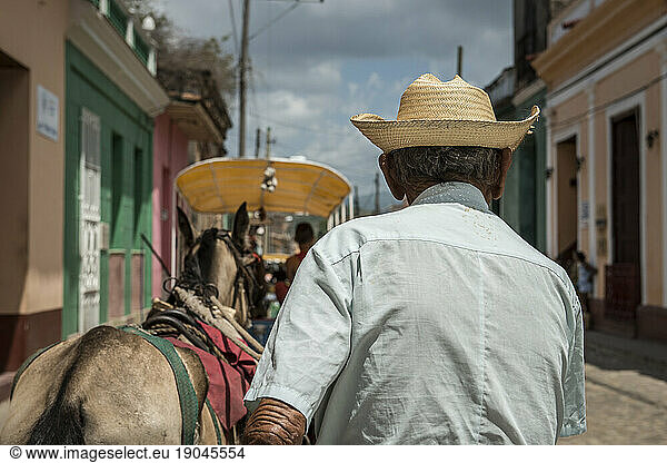 An elderly Cuban carriage driver and his horse - passenger POV - Trinidad  Sancti Spiritus  Cuba
