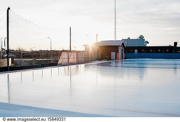 an empty outdoor ice rink at sunset in Sweden