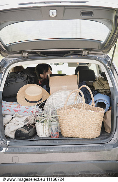 An estate car trunk full of bags and belongings.