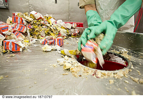 An inmate sorts food waste at Stafford Creek.