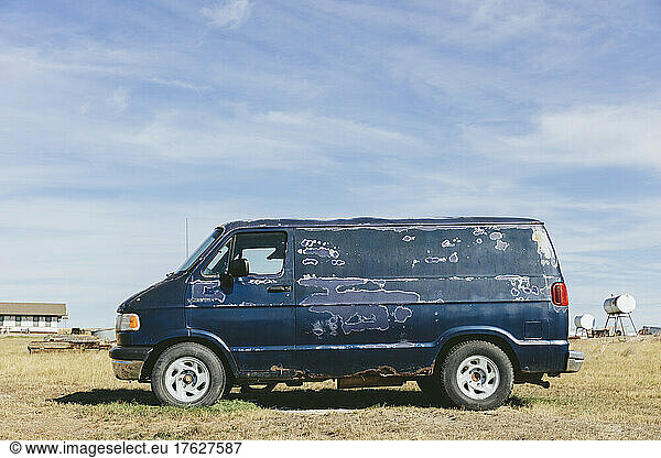 An old abandoned van in a field in Montana.