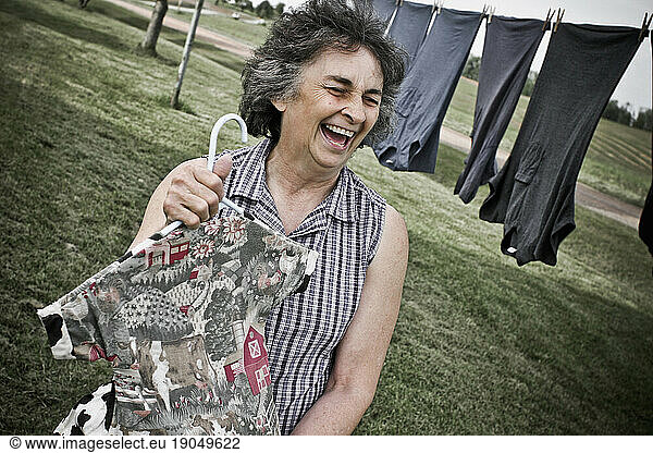 An older woman doing laundry in her backyard of her house on her family's dairy farm in Keymar  Maryland
