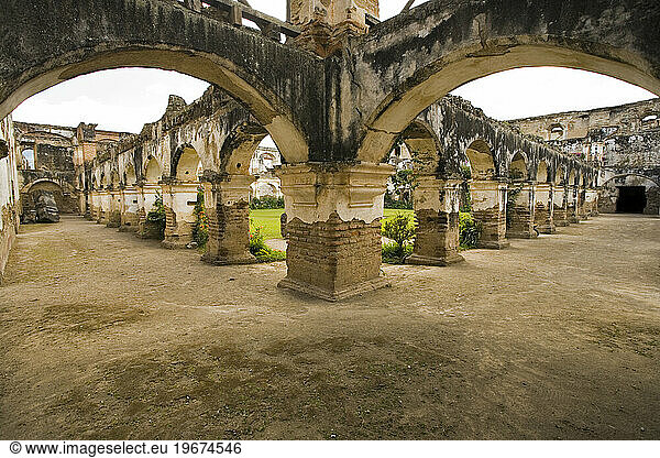 An open courtyard and garden of the ruins of the old church Santa Clara  Antigua  Guatemala