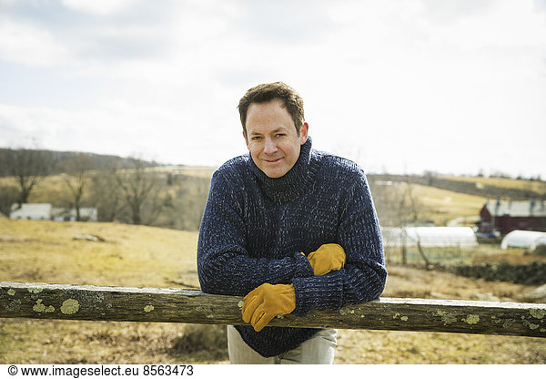 An Organic Farm in Winter in Cold Spring  New York State. A man working outdoors on the farm.