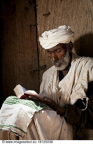 An Orthodox Christian man reads from the bible at Bet Medhane Alem  Lalibela  Northern Ethiopia.