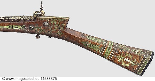 An Ottoman gold-inlaid miquelet-lock rifle  18th century Round  seven-groove rifled Damascus barrel in 13 mm calibre with fixed rear sight. The top of the barrel up to the muzzle (slots at the barrel rings) completely inlaid with blossom tendrils and golden master's mark. Gold-inlaid miquelet-lock (the tension lever at the cock is missing). Maple full stock with bone nose. The butt and the lock extensively inlaid with pins made of bone and brass  some of them coloured green. Five silver  engraved barrel rings  iron ramrod. Length 100.5 cm  historic  historical  18th century  Ottoman Empire  firearm  fire arm  gun  fire arms  firearms  guns  handgun  weapon  arms  weapons  arms  object  objects  stills  clipping  clippings  cut out  cut-out  cut-outs