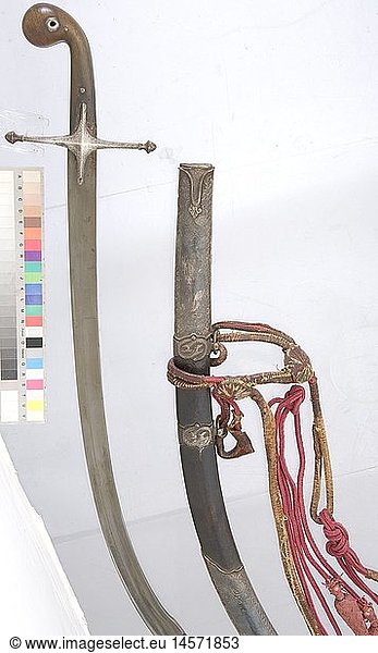 An silver-mounted Ottoman kilij with suspension  circa 1800 Blade with wide fullers on both sides  a reinforced back  and a broad double-edged point. Quillons engraved with geometric designs. Chased silver grip strap with floral designs. Riveted rhinoceros horn grip scales. Wooden scabbard covered with shagreen leather sewn with silver wire and with silver mountings bearing embossed floral designs. A serpent-shaped monster on the two suspension bars. Silver is darkened  chape has dents  the locket is slightly dented at the opening. Length 100 cm. The attached  partially leather-backed  silk suspension with two tassels and round strap segments. historic  historical  19th century  Ottoman Empire  thrusting  thrustings  hand weapon  hand weapons  melee weapon  melee weapons  handheld  blade  blades  weapon  arms  weapons  arms  object  objects  stills  clipping  clippings  cut out  cut-out  cut-outs