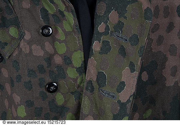 An SS paratrooperÂ´s smock  pea-dot camouflage pattern Cotton cloth production circa 1944  imprinted with 'Erbstarn' (pea-dot) camouflage pattern. Covered button fly  Bakelite buttons  zippers  sleeves with Prym push buttons  stitched-on pistol holster. Correct style SS eagle  factory-applied. Grey-green inner liner size stamped I. Original piece  one of the rarest SS camouflage uniform items. USA-Los historic  historical  20th century  1930s  1940s  Waffen-SS  armed division of the SS  armed service  armed services  NS  National Socialism  Nazism  Third Reich  German Reich  Germany  military  militaria  utensil  piece of equipment  utensils  object  objects  stills  clipping  clippings  cut out  cut-out  cut-outs  fascism  fascistic  National Socialist  Nazi  Nazi period