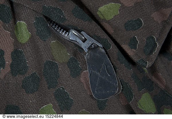An SS paratrooperÂ´s smock  pea-dot camouflage pattern Cotton cloth production circa 1944  imprinted with 'Erbstarn' (pea-dot) camouflage pattern. Covered button fly  Bakelite buttons  zippers  sleeves with Prym push buttons  stitched-on pistol holster. Correct style SS eagle  factory-applied. Grey-green inner liner size stamped I. Original piece  one of the rarest SS camouflage uniform items. USA-Los historic  historical  20th century  1930s  1940s  Waffen-SS  armed division of the SS  armed service  armed services  NS  National Socialism  Nazism  Third Reich  German Reich  Germany  military  militaria  utensil  piece of equipment  utensils  object  objects  stills  clipping  clippings  cut out  cut-out  cut-outs  fascism  fascistic  National Socialist  Nazi  Nazi period