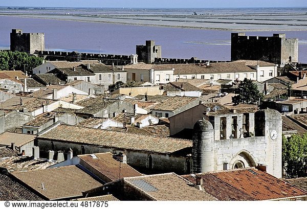 Ancient city walls and roof tops with Notre Dame des Sablons in view,  Aigues-Mortes,  France