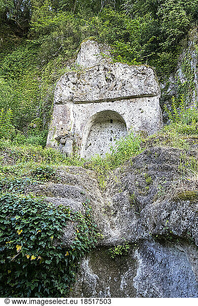 Ancient stone structures amidst plants  Tuscany  Italy