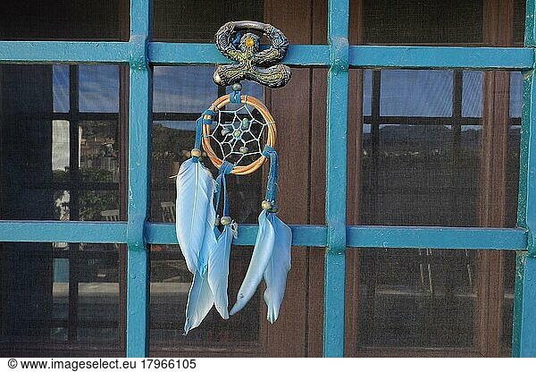 Andalusian Lucky Charm Indalo and Dreamcatcher on Iron Grille of Window