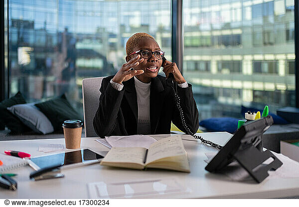 Angry black manager talking on telephone