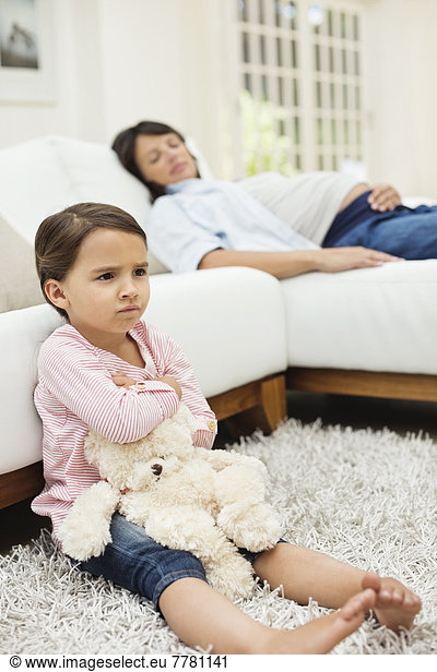 Angry girl watching television with mother