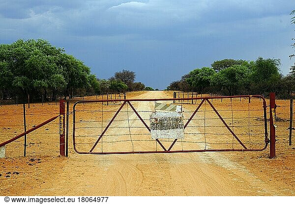 Animal enclosure  road D2512  rain clouds  Republic of Namibia
