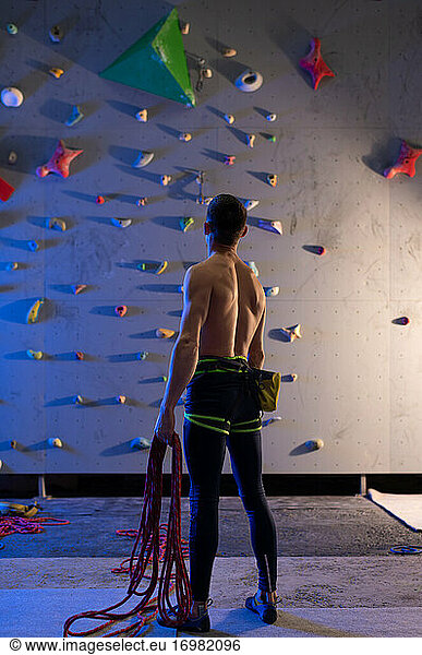 Anonymous climber examining wall during workout