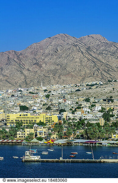 Aqaba city near mountain range on sunny day