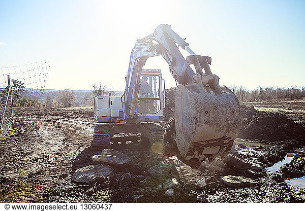 Arbeiter graben Land mit Erdbewegungsmaschine auf der Baustelle