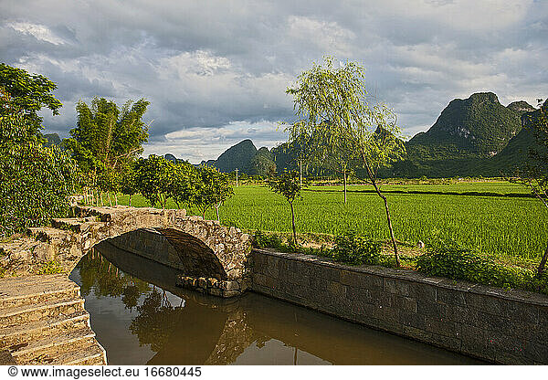 arched pedestrian bridge in rural China close to Yangshuo