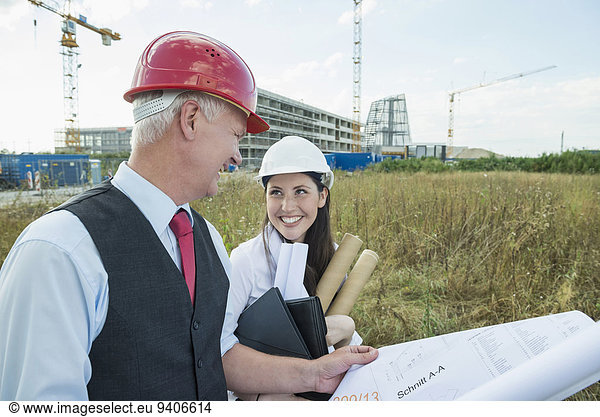 Architect and customer discussing construction plans