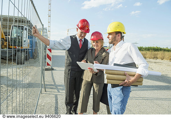 Architect and customers inspecting site