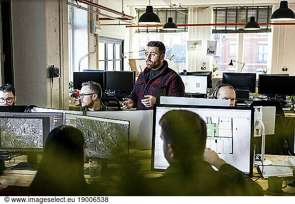 Architects having discussion and working together in office