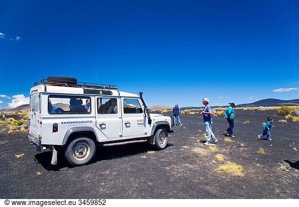 Argentina  Mendoza  Parque Provincial Payunia Tourists and 4 wheel drive jeep exploring the reserve