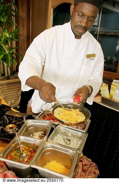 Arkansas  Little Rock  The Peabody Little Rock  hotel  Black  man  cook  omelet station  food  breakfast  eggs  food preparation  job  ingredients