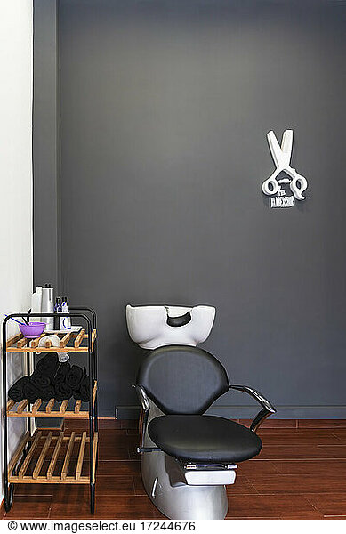 Armchair in front of black wall at barber shop