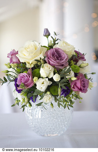 Arrangement of white  pink and purple wedding flowers.
