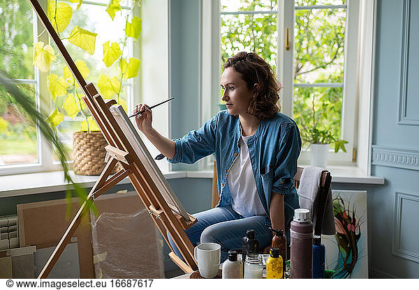 Artist creating artwork in home studio