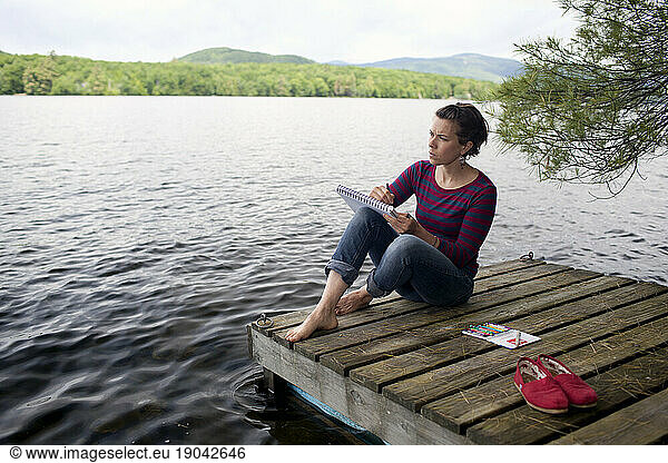 Artist drawing beautiful views from dock at Kezar Lake