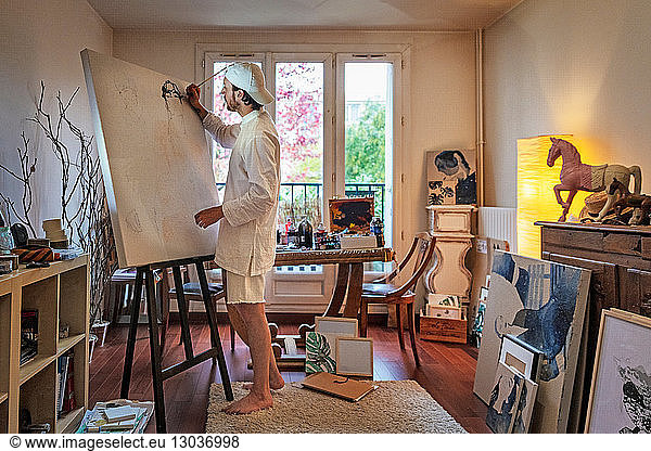 Artist working on canvas in studio