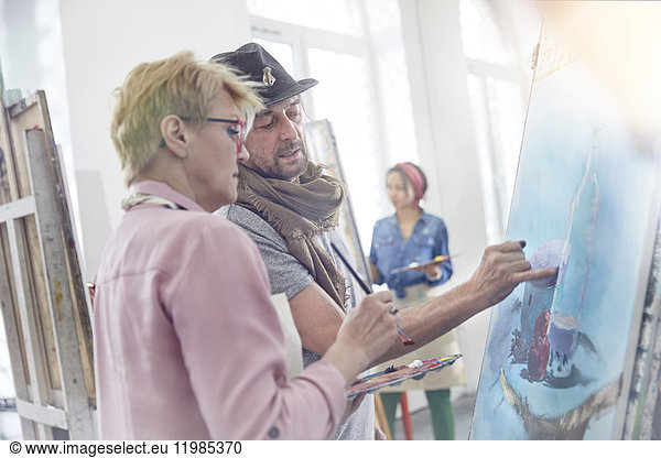 Artists painting in art class studio