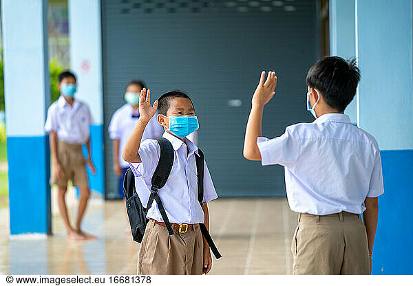 Asian children in school uniform wearing protective mask to Prot