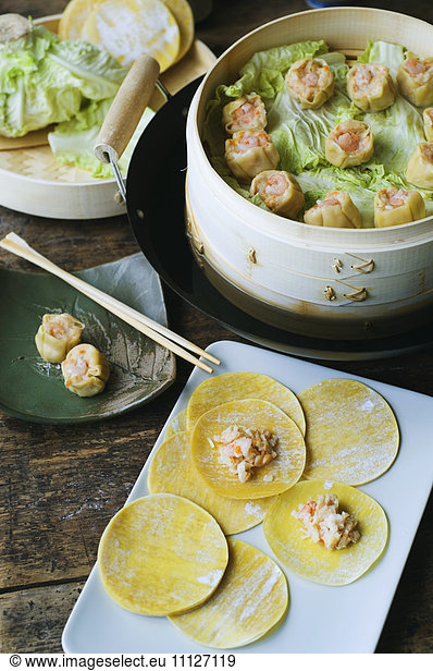 Asian dumpling in steamer with cabbage