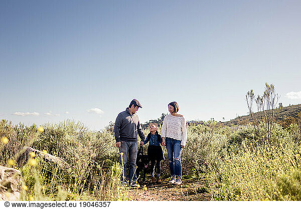 Asian Family of Three Standing in Wildflowers in San Diego