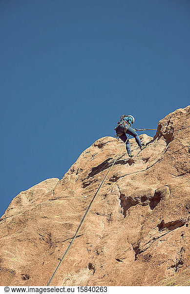 Asian Female Rock Climber Descending at Garden of the Gods Colorado