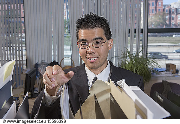 Asian man with Autism working in an office