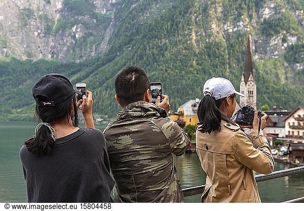 Asian tourists photograph the old town of Hallstatt  cultural landscape Hallstatt-Dachstein Salzkammergut  Upper Austria  Austria  Europe