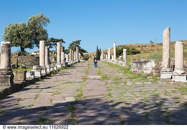 Asklepieion (also spelled Asclepieion  Asclepion  Asklepion  Asclepeion)  near Bergama  Izmir Province  Turkey. A visitor strolls along the main street  known as the Sacred Way  which leads to and from the ancient medical centre.