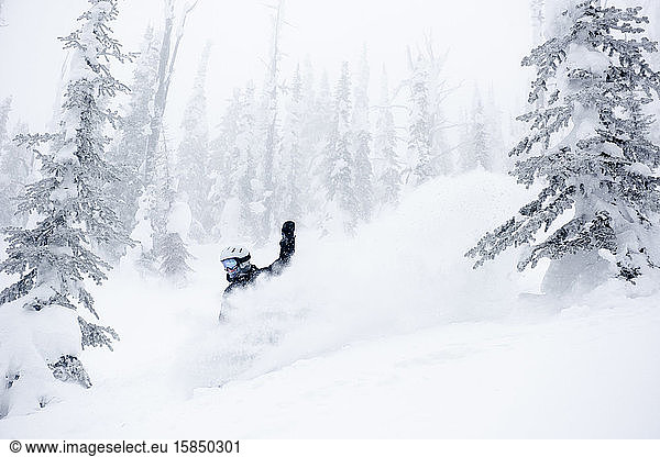 Asnowboarder finds pure happiness taking a turn in deep powder