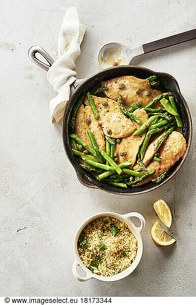 Asparagus  lemon and caper skillet chicken with a side dish of couscous