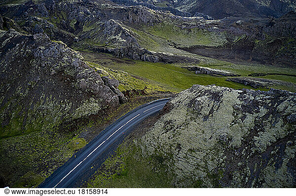 Asphalt road through mountainous terrain